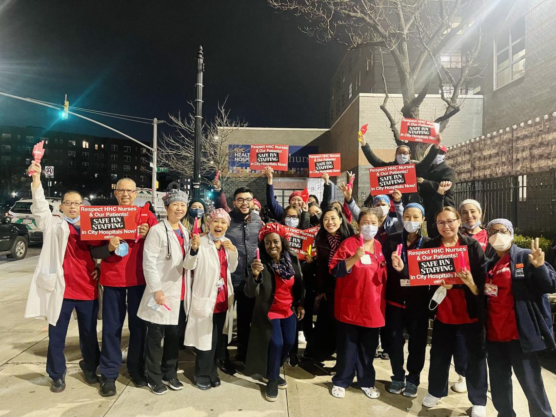 Elmhurst nurses gather outside the hospital with signs demanding Safe R.N. Staffing 