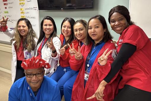 Lincoln Hospital nurses in scrubs smiling with peace hand signs