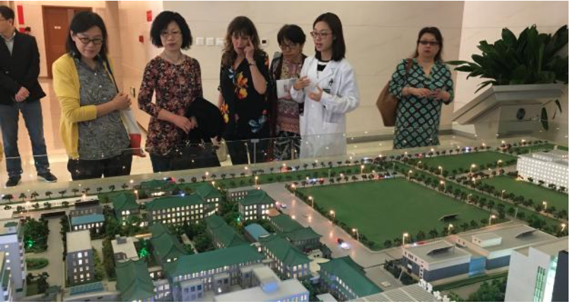 Nurses look at model replica of Peking Union Medical Hospital