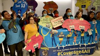 Advocates hold #Coverage4All signs