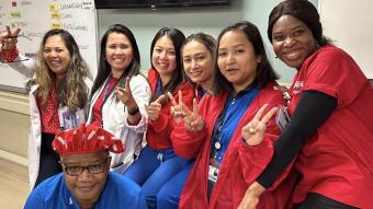 Lincoln Hospital nurses in scrubs smiling with peace hand signs