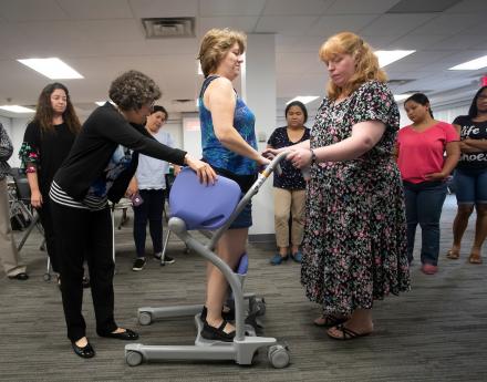 Nurses and instructor demonstrating safe mobility practices of patients