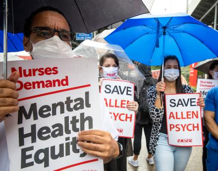 Nurses holding signs that say "Nurses Demand Mental Health Equity" and "Save Allen Psych"