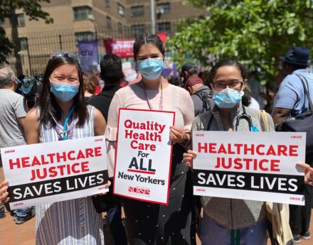 Nurses hold signs that say Quality Health Care For All New Yorkers