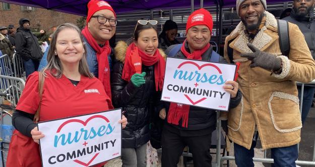 NYSNA members holding Nurses + Community signs